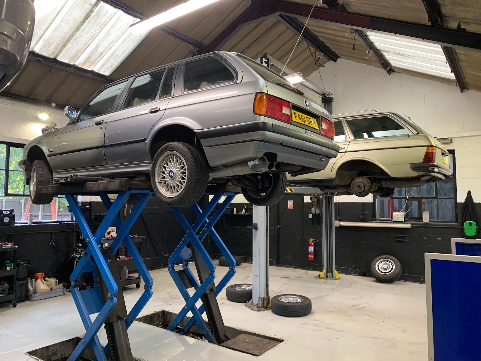 A pair of classic BMWs up on the ramps