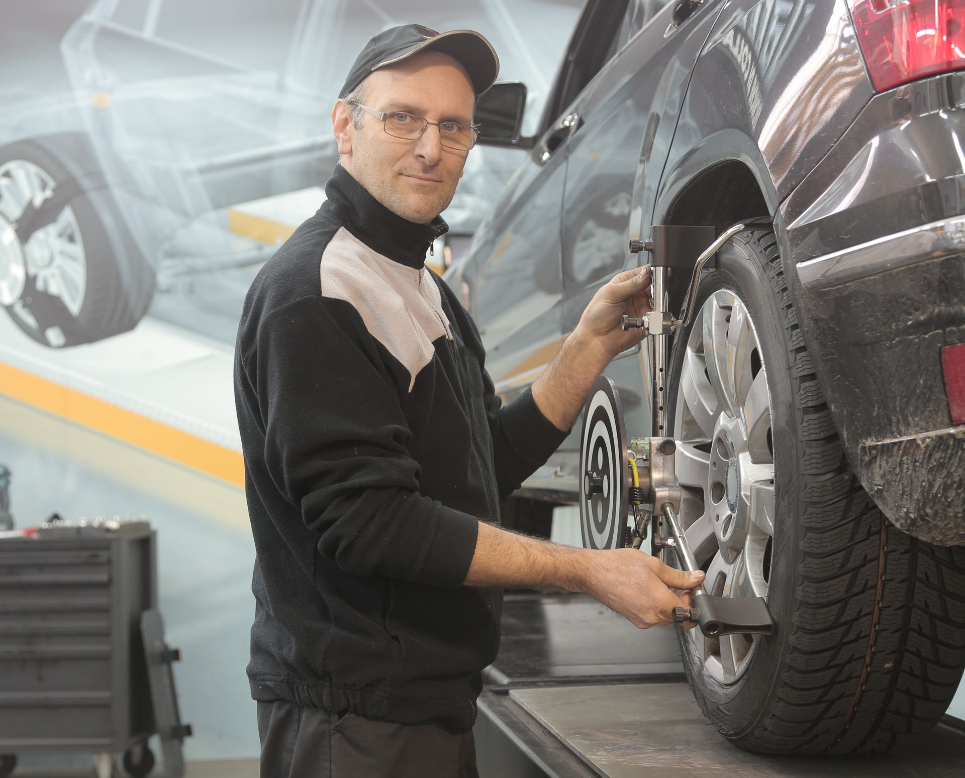 A technician working under the bonnet at Kings Worthy Garage in Winchester